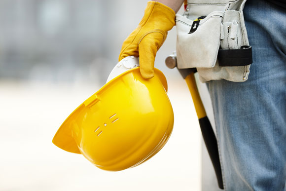 a worker holding a helmet providing services such as General Contractor, Home Renovations, and Home Builder in Westlake