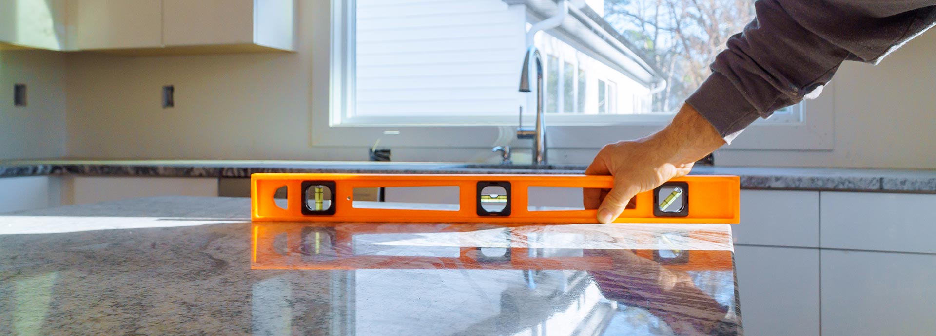 general contractor using a level before performing Home Renovations and Home Remodeling in Austin
